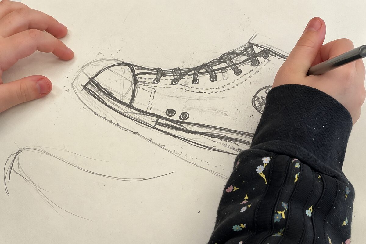 Art 1 student drawing a sneaker