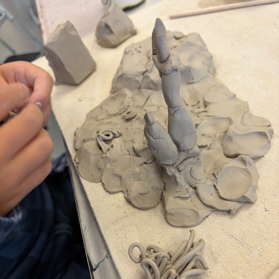 Student working on a clay sculpture
